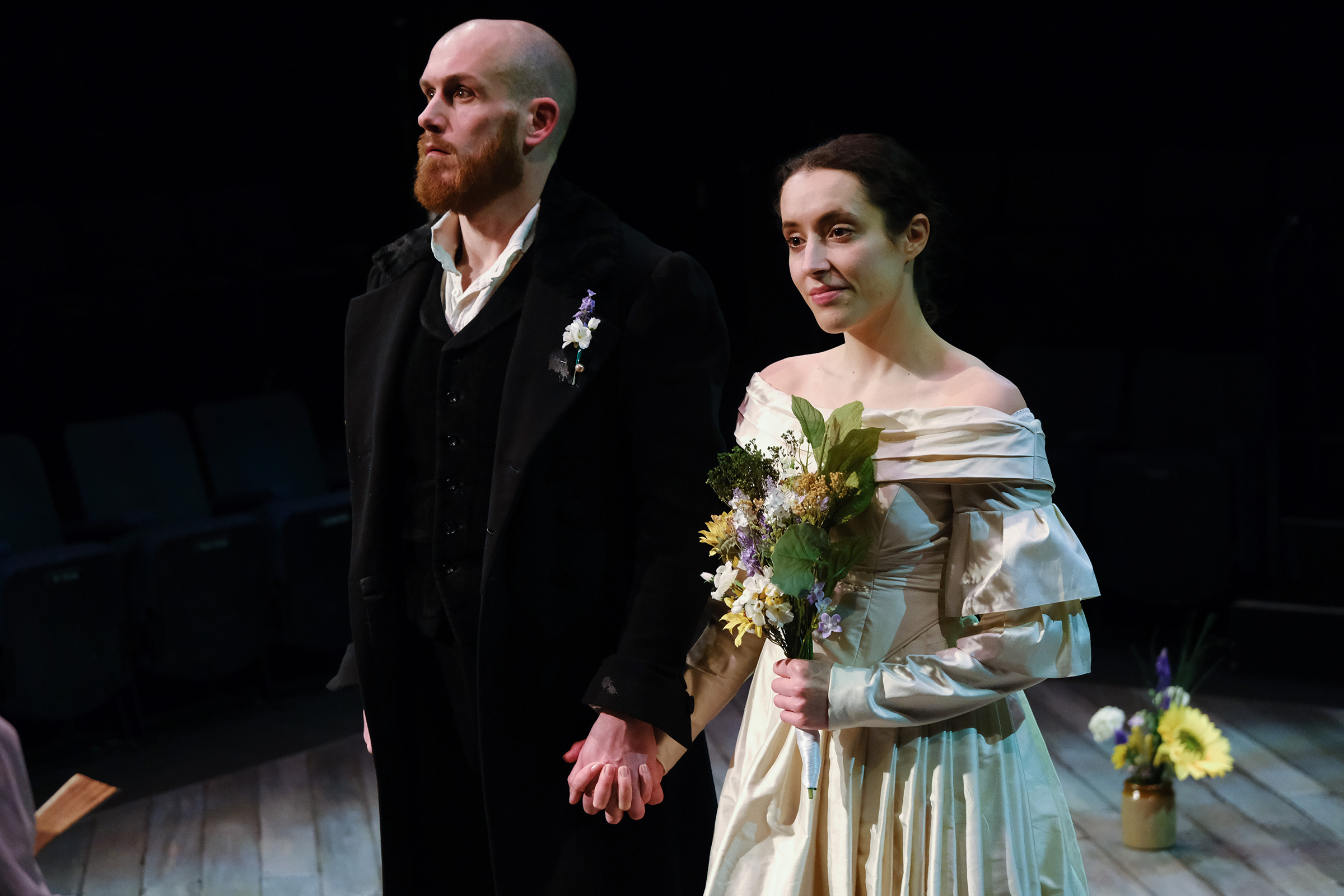 theatre performance image: Jane Eyre and Rochester are standing at the altar in wedding clothes